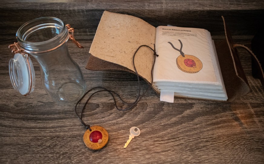 spell book and magical amulet for wizard escape room